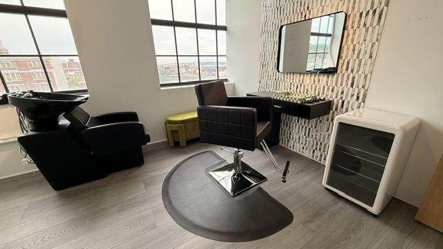 Hair Studio: wide angle showing wash basin, styling chair, and Brooklyn skyline through the windows.