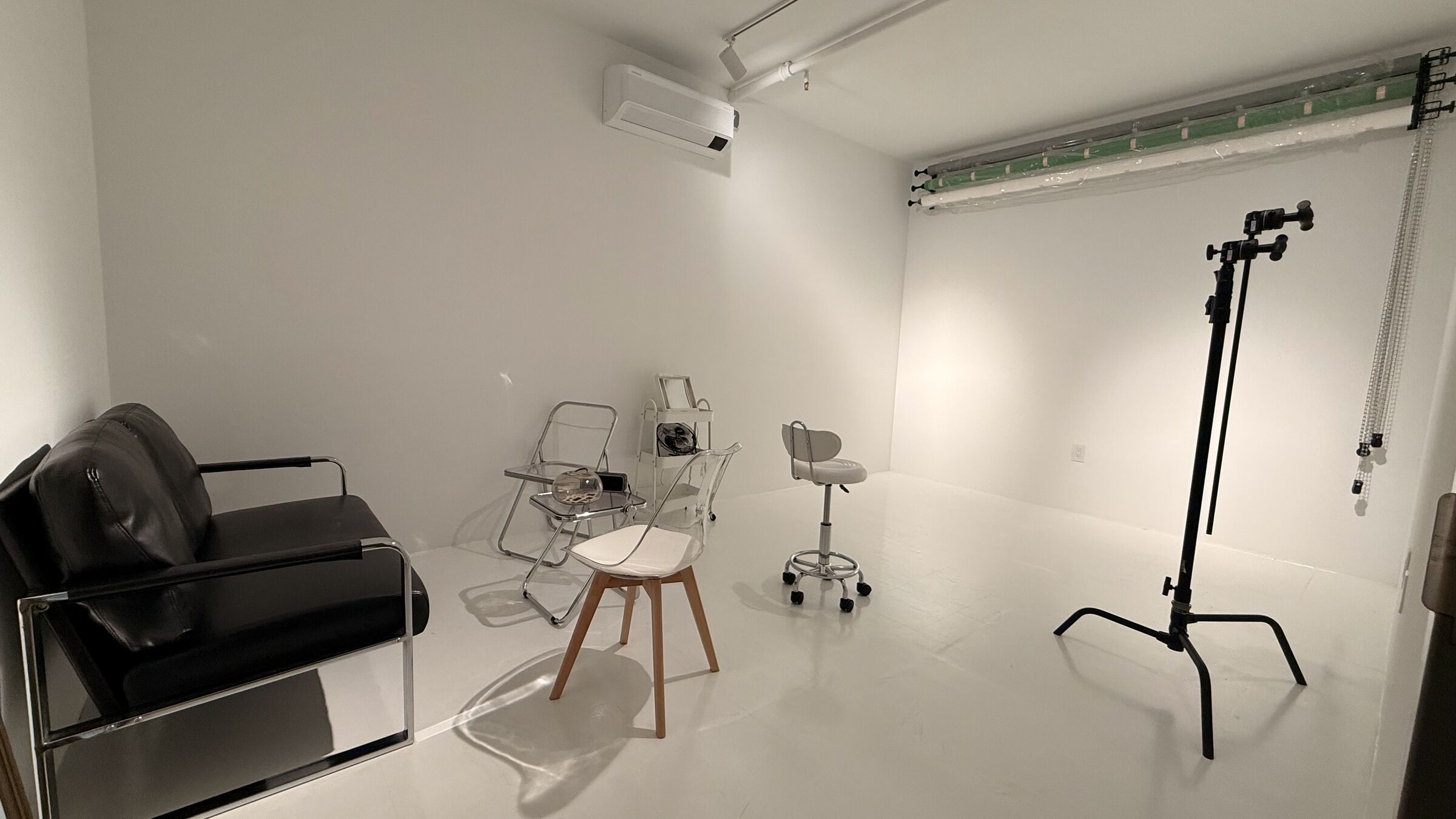 Portrait Studio: alternate angle showing the couch and C-stand mid-ground, backdrop rig along the back wall.